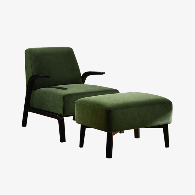 Moderne groen fluwelen fauteuil met armleuning en poef